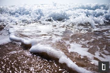 A close view of water and light creating a soft silver surface.