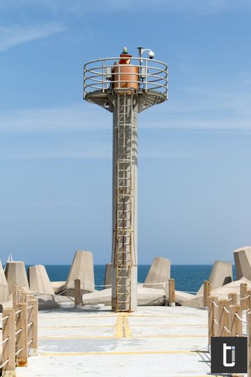 A lighthouse standing against a clear blue sky.