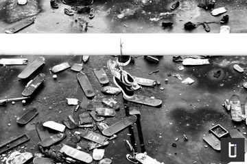 A collection of discarded skateboards on a London bridge.